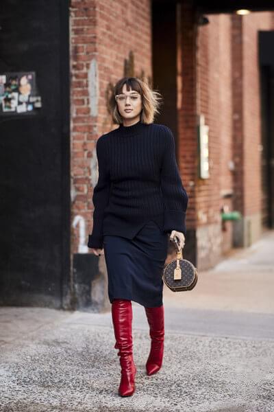 Midi skirts hems and thigh-high boots overlap, making one stylish and very polished combination. This is one of the solutions on how to style your tall boots for work.