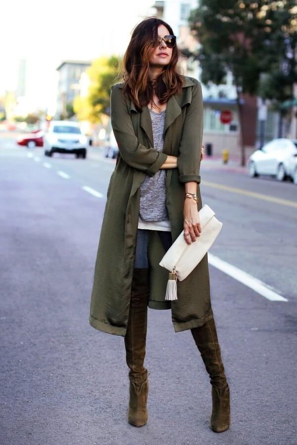 Green parka, a grey blouse, jeans, and super cool tall boots