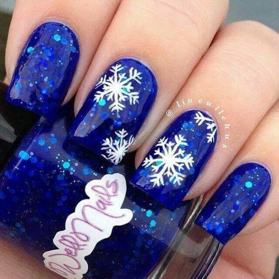 Different colors on your nails can make you stand out from the crowd. Dark blue with sequins is one of those shades. #winternails #naildesign