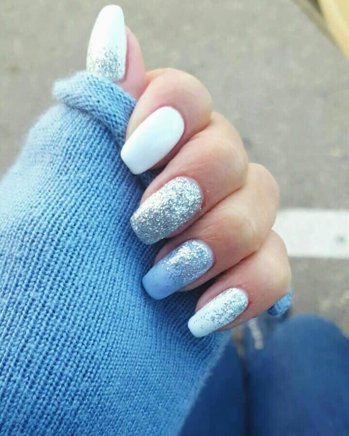 Match with the snowy weather outside with light blue nails with a lot of sparkly details on them. #winternails #naildesign