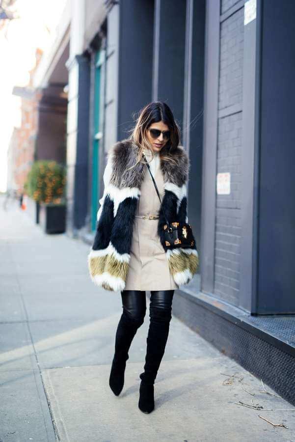 Looking cool in winter? No problem. Match a colorful faux fur vest with a beige dress, leather leggings, and tall boots. Leggings will keep you extra warm and cozy. #bootsoutfit #nighout #nightoutlook