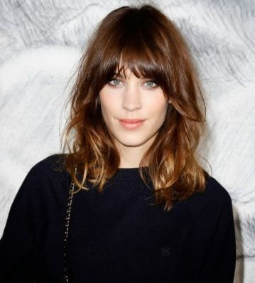 Go wild with this shoulder length curly do and bangs.