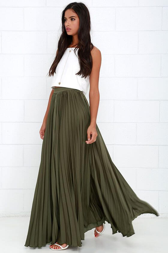 Elegant woman in olive green maxi skirt and white top combination. Olive green skirt and white crop top.