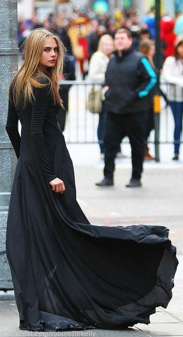 Model in the form-fitting, figure-hugging long-sleeved black maxi dress. A bit gothic black maxi dress.