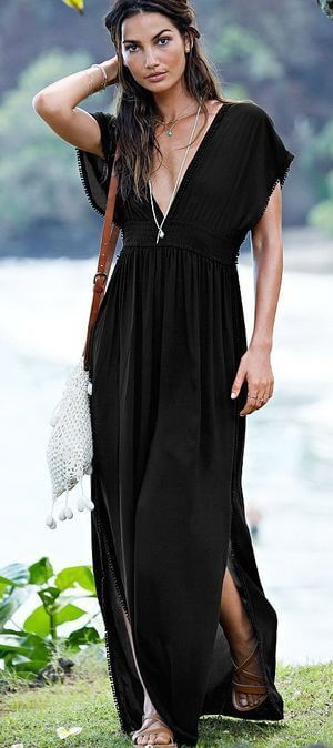 Woman standing outside in black cover-up maxi dress. Maxi dress suitable for relaxing summer vacations.