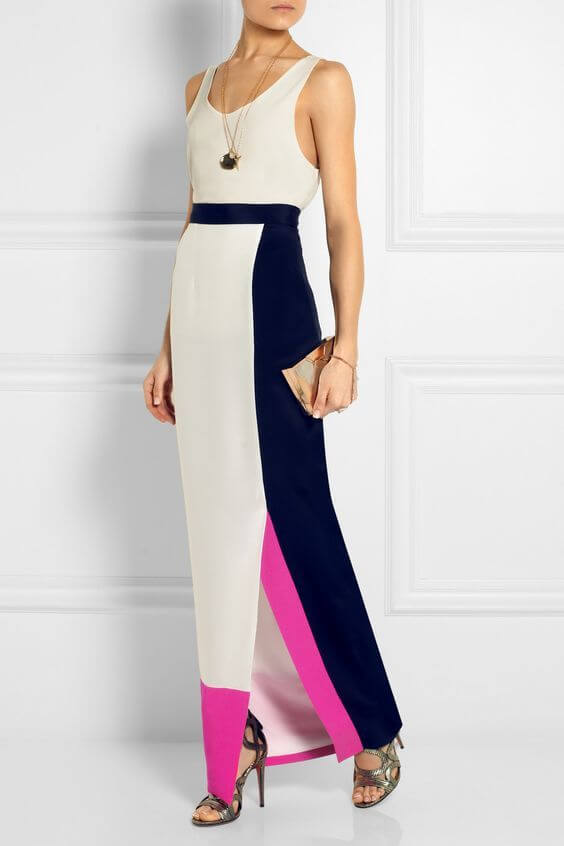 Woman in a slim maxi dress, decorated with elements of white, navy, blue and magenta. Simplicity is a key to elegance.
