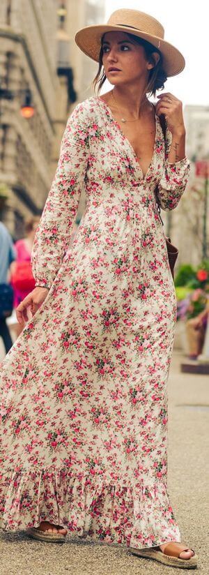 Woman walking in long floral dress. Woman in long gorgeous floral dress.
