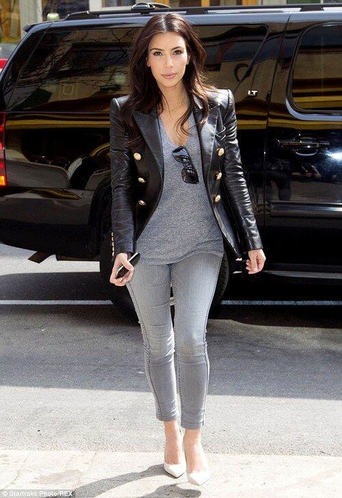 Layers over Skinny Jeans: Kim Kardashian perfectly pairs gray skinny jeans with a draped gray T-shirt and black leather jacket.