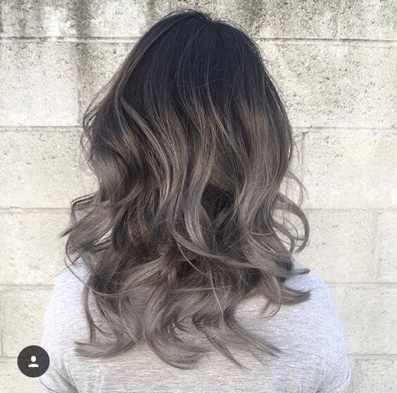 black, medium length wavy hair with silver ombre gradient