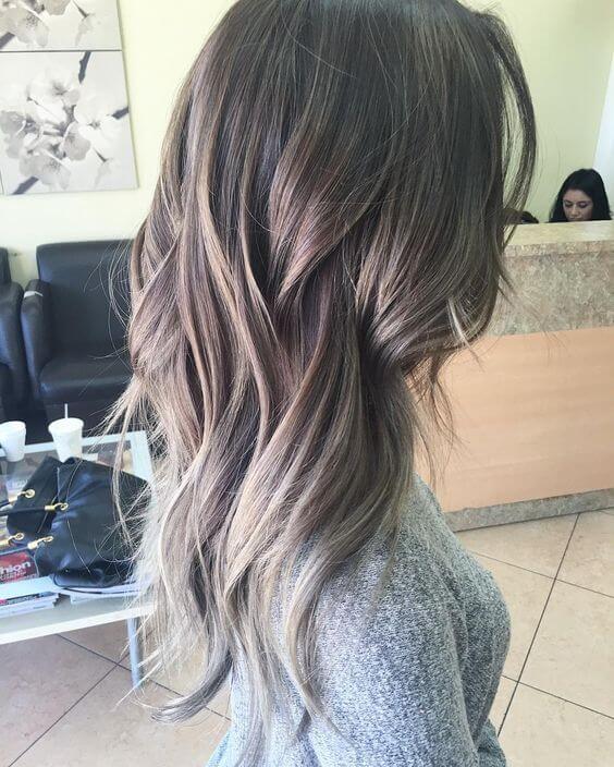 Medium length wavy hair with blonde and gray ombre