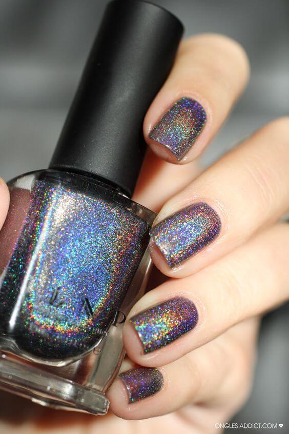 This holographic polish has more dark blue and purple hues, but still reflects rainbow light.