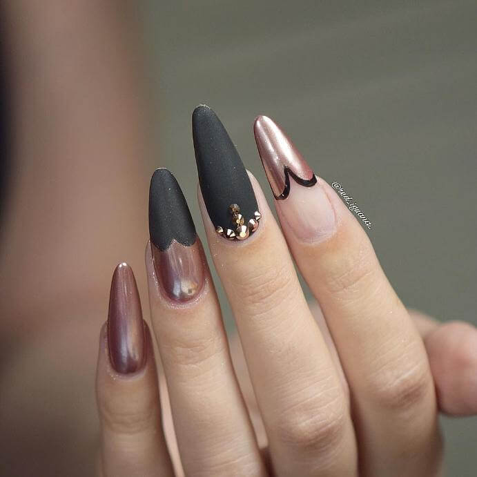Using both matte black, metallic pink, and clear nail polish, this artist has created a unique look.