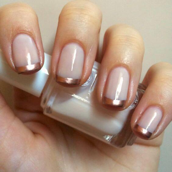 Cash in on the rose gold trend by using pink and gold tones in your French manicure.