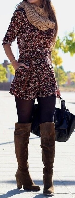 Woman wearing a floral romper, navy blue opaque tights, tan scarf and brown boots