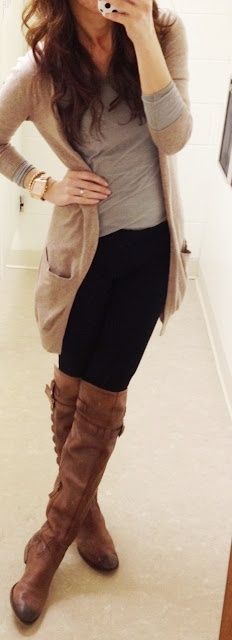 Woman wearing a gray top, long beige cardigan, black leggings and over-the-knee brown leather boots