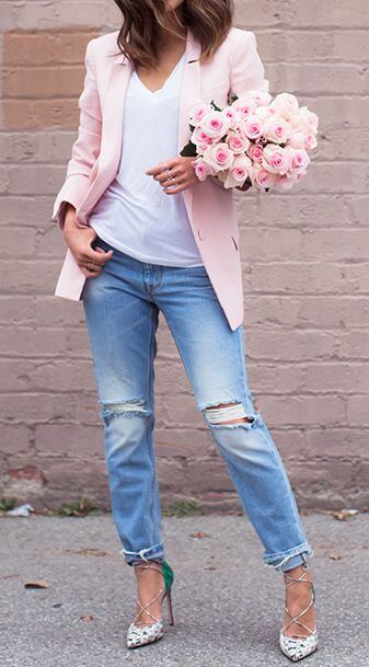 A touch of baby pink adds a feminine touch to casual boyfriend jeans.