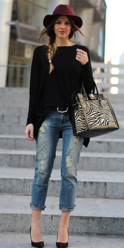 A draped black top adds volume and shape to boyfriend jeans.