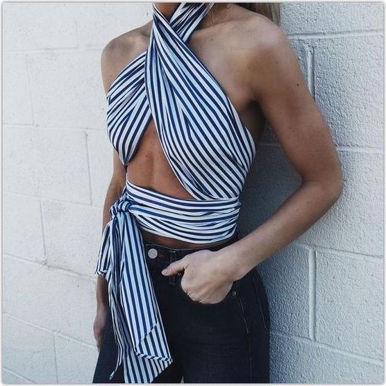 Chic woman in wrapped striped scarf and blue jeans. As the heat rises, a striped scarf can do wonders to keep you cool!