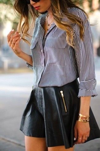 Edgy woman in black leather skirt and striped shirt