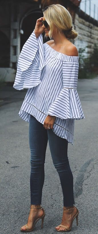 Stylish blonde in skinny jeans and striped off-the-shoulder top