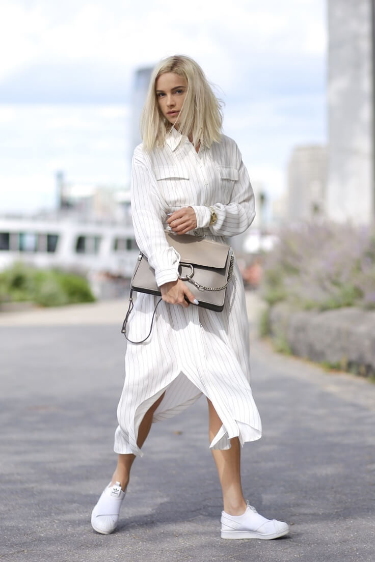 Blondie with midi length linen shirt dress and white sneakers representing cozy-glam look.