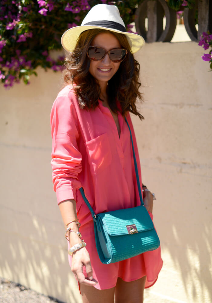 Smiling woman wearing coral shirtdress to create a beachy look