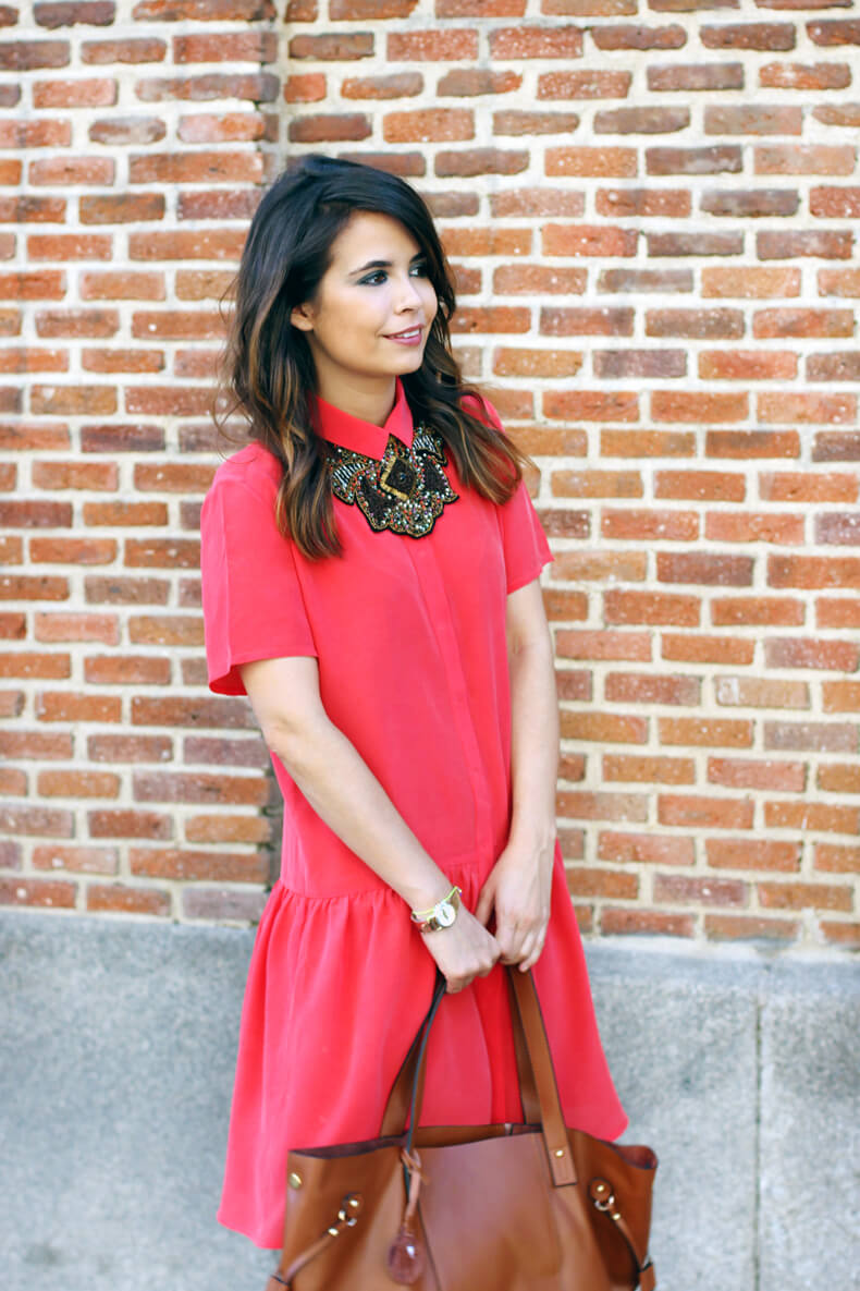 Girl wearing coral shirt dress and statement-making necklace like accent.