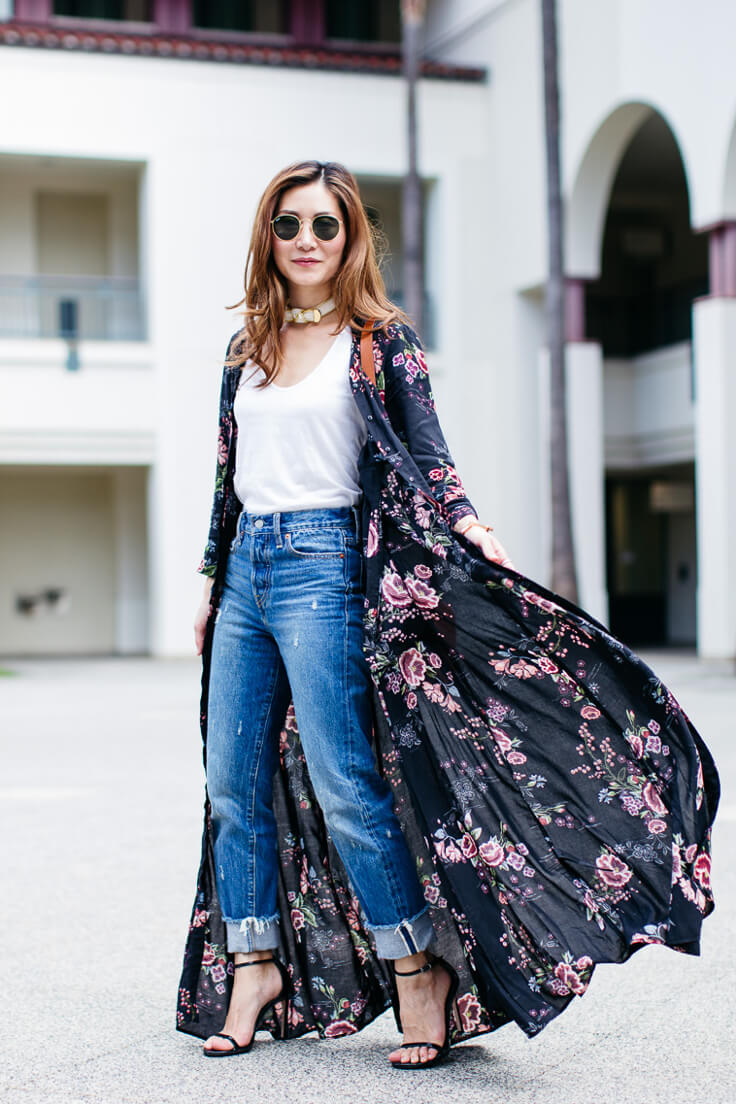 Woman with ribbed boyfriend jeans, white top and flower pattern shirt dress worn like a long cardigan for an effortlessly chic look.