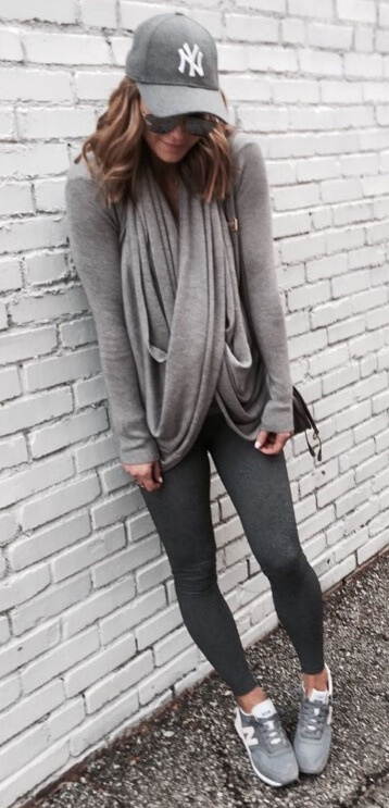 The athleisure trend was designed especially for easygoing fall days. Look your comfortable best in charcoal leggings, a fitted gray sweater plus a draped gray scarf in the same color. To up the sporty effect, be sure to throw on trendy New Balance sneakers and your favorite baseball cap.