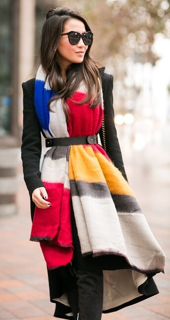 Keen to make a color splash this season? Look for solid blocks of bold color in red, mustard and black like in this long, belted scarf.