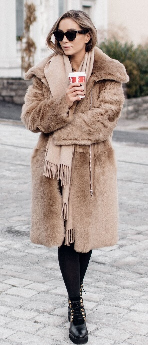Cool fall temperatures mean you can finally take that luscious fur coat out of storage. This standout piece is an outfit in itself. All you need to go along with it are black leggings, Doc Martin boots, and a fringed beige scarf.