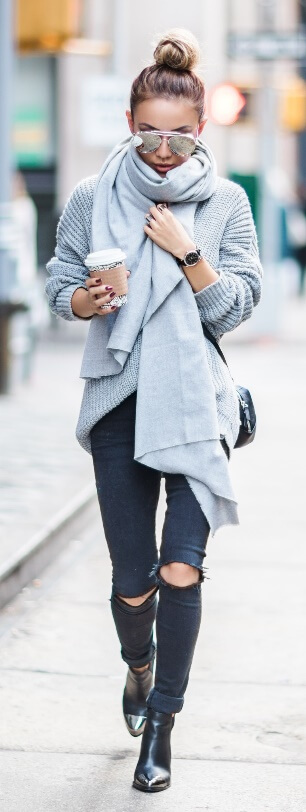 Here we have every street style star's everyday uniform: ripped black skinny jeans, black leather booties plus beautiful dove gray basics. Give it a full spin with an oversized gray sweater and matching oversized wrap around pashmina scarf.