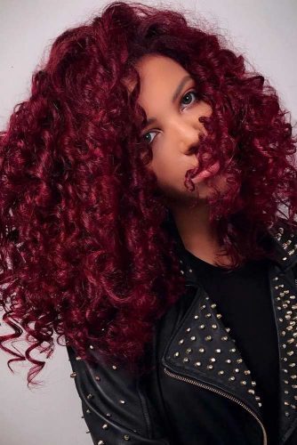 These gorgeous curls consist of a unique color that mixes shades of purple and red, beautiful on darker skin.