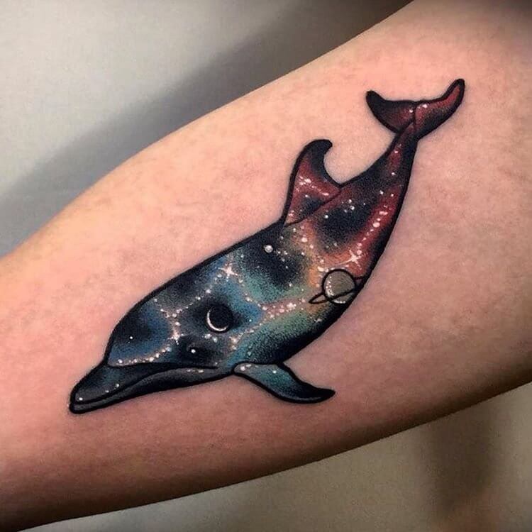 You will be absolutely unique wherever you appear with this galaxy-dolphin tattoo on your forearm. #summertattoo #colorfultattoo