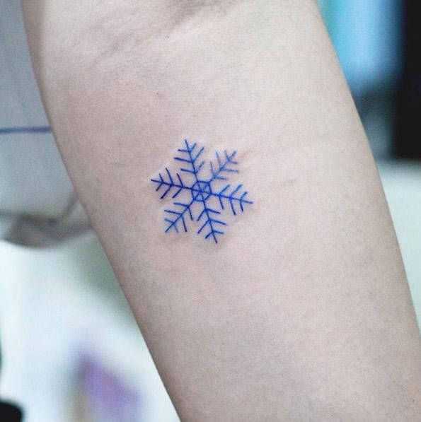 Snowflake tattoo in blue ink #wintertattoo