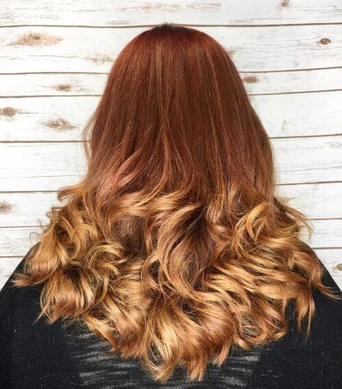 Stay with dark auburn tones at the roots and finish this ombre look with some golden ends.