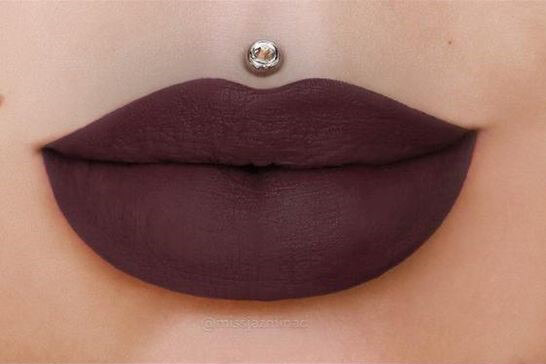 Top off your fall wardrobe with a dark purple lipstick.