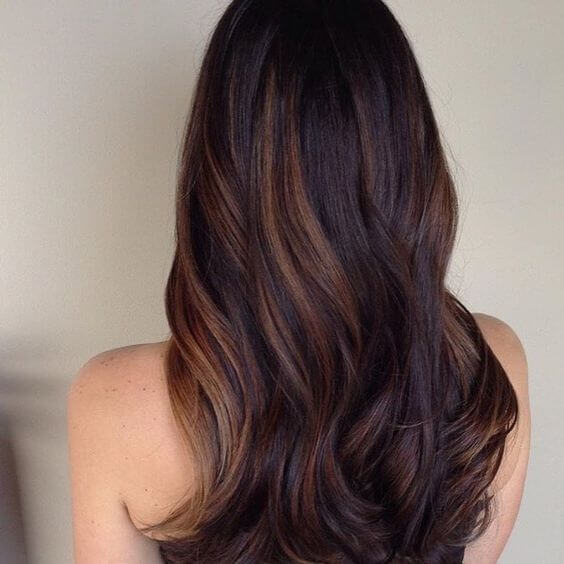 Dark brown hair with thick caramel highlights