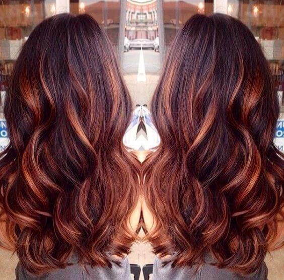Wavy brown hair with red lowlights and copper highlights