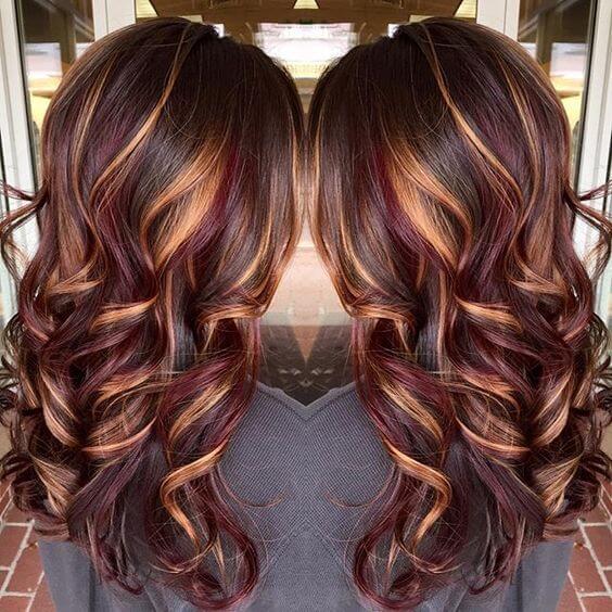 wavy light brown hair with golden blonde and dark red highlights