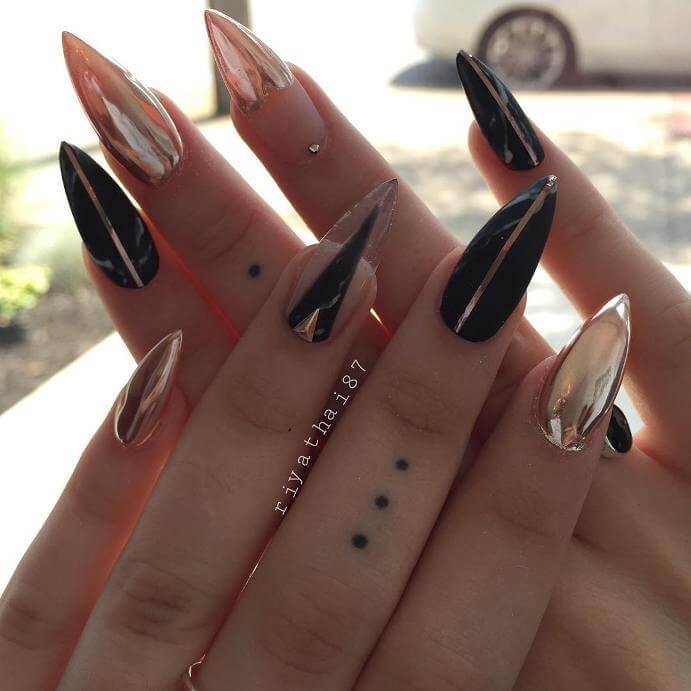 This unique manicure uses different patterns to create a cool asymmetrical effect.
