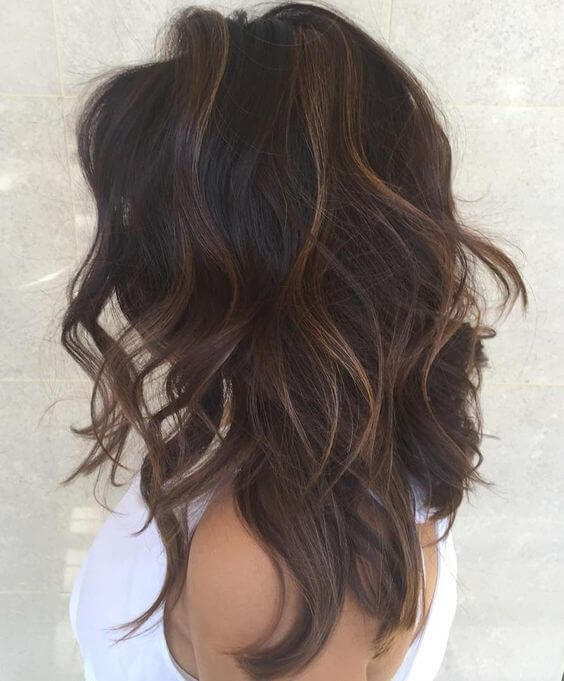 Dark brown hair and subtle blonde highlights is a way to get a new spring look with minimum damage to your hair