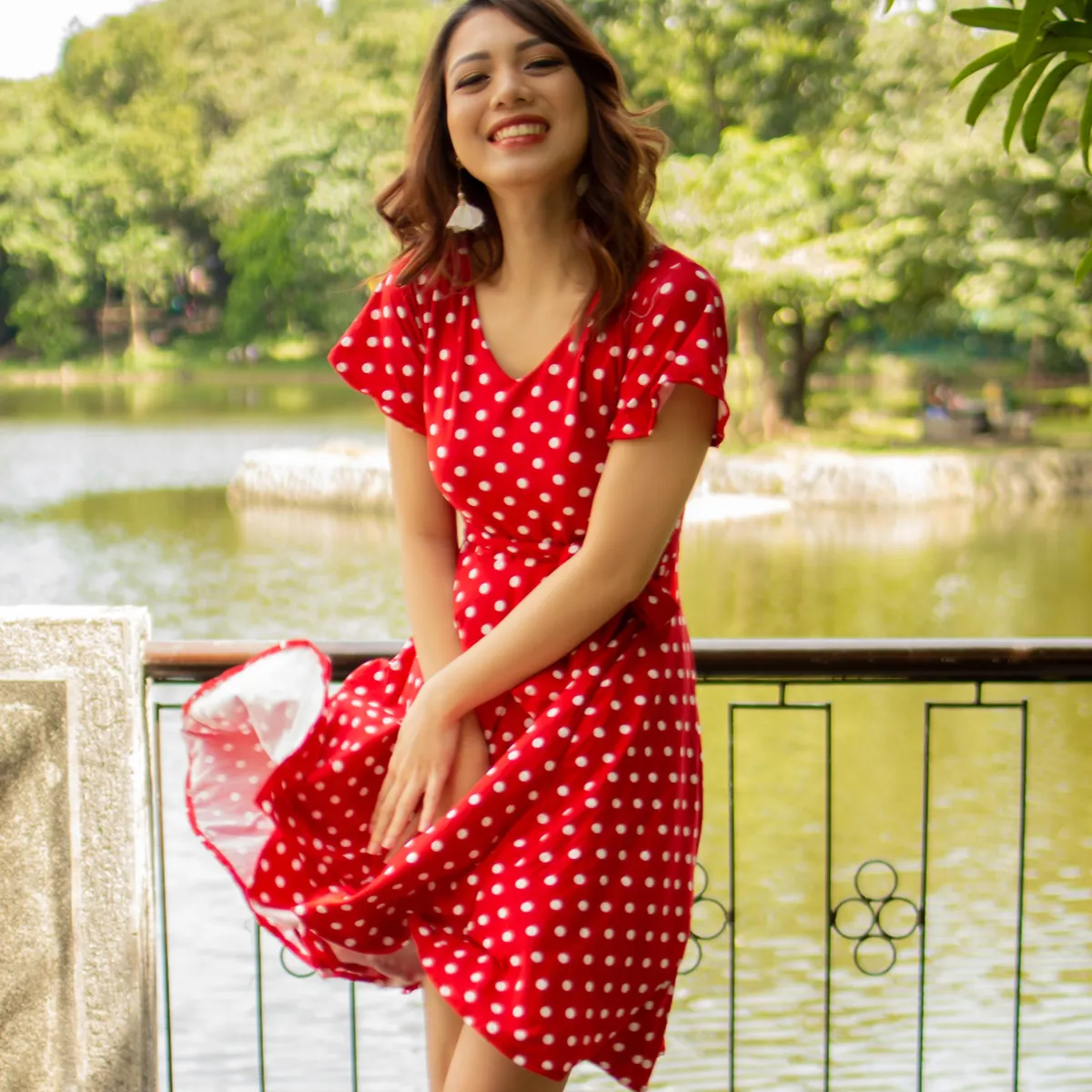 Woman dressed in classic French wardrobe: red polka dot dress