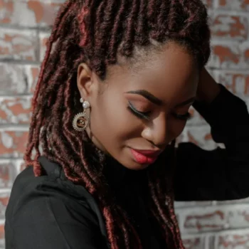 A portrait of pretty African woman with dreadlocks faux locs hairdo and stylish makeup