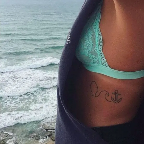 This is a delicate place for an even more delicate tattoo. Anchor and wave - perfect summer combination!