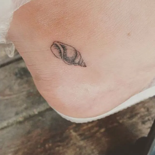 Small and delicate seashell symbol is an amazing tattoo if you are not a fan of big and eye-catching tattoos
