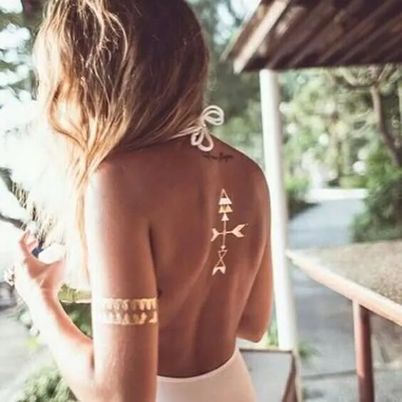 Arrows on your back in combination with bracelet tattoo on your forearm can look perfect in the summer. Don’t forget to wear dresses and tops with an open back and sleeveless.