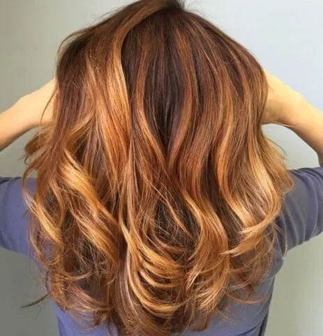 Combination of honey, brown, and auburn highlights create a beautiful hairstyle.