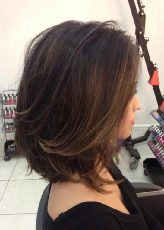 Highlight parts of your hair with light brown shade. The rest of your hair should be in a dark and warm black tone.