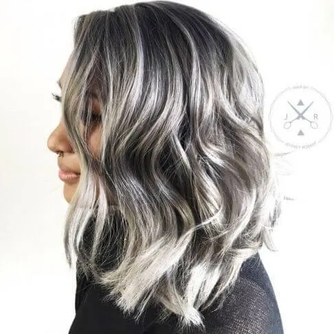 Make a perfect contrast on your hair by highlighting your black hair with white and grey shades.